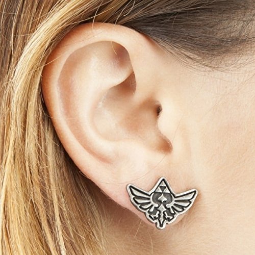 Close-up of Legend of Zelda earrings on ear

